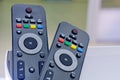 Two several many pieces of black, dark gray TV remote control channel switching, on a light, white background