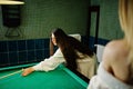 Two sexy girls in white bathrobe and swimsuit play pool billiards Royalty Free Stock Photo