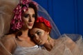 Portrait of the two gorgeous ladies with wild flowers. Elegance.  Wreaths  Fantasy Royalty Free Stock Photo