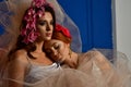 Portrait of the two gorgeous ladies with wild flowers. Elegance.  Wreaths  Fantasy Royalty Free Stock Photo