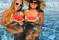 Two women with dark hair eating watermelon Royalty Free Stock Photo