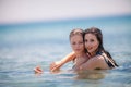 Two Young Girls having fun at the beach inside the sea Royalty Free Stock Photo