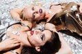 Two young women with gothic halloween makeup lying