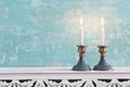 Two shabbat candlesticks with burning candles over wooden table Royalty Free Stock Photo