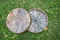 Two Shaman& x27;s tambourine made of genuine leather lie on the green grass.