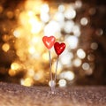 Two sharp pins in the form of red hearts stuck in the burlap on Royalty Free Stock Photo