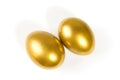 Two shiny golden eggs on white background Royalty Free Stock Photo