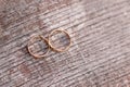 Two golden wedding rings on wood background Royalty Free Stock Photo