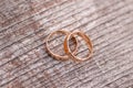 Two golden wedding rings on wood background Royalty Free Stock Photo