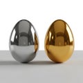 Two Shiny Metallic Eggs, One Gold and One Silver, on a Gray Surface image photo Royalty Free Stock Photo