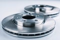 Two shiny new metallic vehicle brake discs resting on a reflective surface showcasing precision engineering and smooth circular Royalty Free Stock Photo