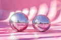 Two shiny pink disco balls are reflected in a pink background Royalty Free Stock Photo