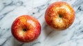 Two Juicy Red Apples on a Marble Surface: A Fresh and Vibrant Still Life Royalty Free Stock Photo