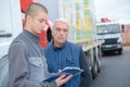 two shipping company workers at container yard