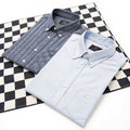 Two shirts on a checkered surface isolated on white background Royalty Free Stock Photo