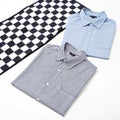 Two shirts on a checkered surface isolated on white background Royalty Free Stock Photo