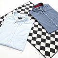 Two shirts on a checkered surface isolated on white background Royalty Free Stock Photo