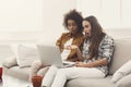 Two beautiful women using laptop at home Royalty Free Stock Photo