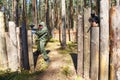 Two shooters with paintball guns defend wooden fortress