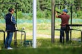 Two shooters in the shooting range of the bench. The man is wearing headphones, the second is ready to shoot. Saint-Petersburg.