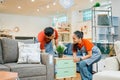 two shop assistants work together to move a small cabinet