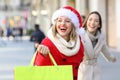 Two shoppers shopping running on the street Royalty Free Stock Photo