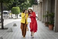 Two shopping women checking their cell phone looking for an address in application