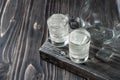 Two shot glasses with cold vodka on wooden table, selective focus Royalty Free Stock Photo