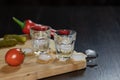 Two shot glasses of vodka on the cutting board