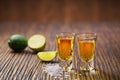 Two shot of gold tequila on a brown wooden background ,selectiv Royalty Free Stock Photo