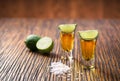 Two shot of gold tequila on a brown wooden background ,selectiv Royalty Free Stock Photo