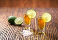 Two shot of gold tequila on a brown wooden background ,selectiv Royalty Free Stock Photo