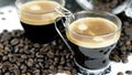 Two shots of espresso sitting in a bed of coffee beans Royalty Free Stock Photo