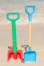 Two shovels stuck on the beach in the sand Royalty Free Stock Photo