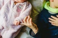 Two siblings, a baby and a toddler shaking hands Royalty Free Stock Photo