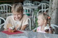 Two siblings having fun eating their sweet Italian gelato ice cream Royalty Free Stock Photo