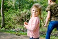 Two siblings kids, Cute little toddler girl and school boy feeding wild geese family in a forest park. Happy children Royalty Free Stock Photo