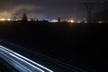 Two side Traffic on the A22 Autobahn in South Tirol, Bolzano in the Background. Long exposure of Lighttrails at night Royalty Free Stock Photo