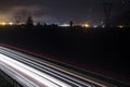 Two side Traffic on the A22 Autobahn in South Tirol, Bolzano in the Background. Long exposure of Lighttrails at night Royalty Free Stock Photo