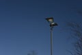 Two sided modern street lamp with dark steel blue sky background