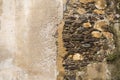 The two sides of the same coin, two ways of showing the same wall, one seeing the stone that forms it and the other covering it Royalty Free Stock Photo
