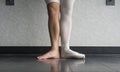 Two sides to a ballerina, one leg wearing her ballet slipper pointe shoe on one foot, and one leg bare Royalty Free Stock Photo