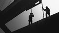 Two Silhouetted Construction Workers on a Metal Beam Royalty Free Stock Photo