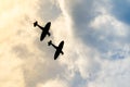 Two silhouetted spitfires dive out of the bright sun, as if attacking an enemy with surprise. Hiding in the sun is an effective an Royalty Free Stock Photo