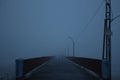 Two silhouettes in the fog reaching over the bridge Royalty Free Stock Photo