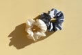 two silk Scrunchies on sunlight with shadows. flat lay of Hairdressing tools and accessories. Hair Scrunchies, Elastic Royalty Free Stock Photo