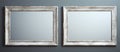 Two silver rectangle picture frames hang on a gray wall