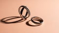 Two Silver Rings on Beige Background Royalty Free Stock Photo