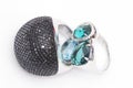 two silver rings with black cubic zirconias and semiprecious stones on a white background