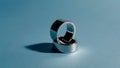 Two Silver Rings Stacked Elegantly on a Minimalist Blue Background Royalty Free Stock Photo
